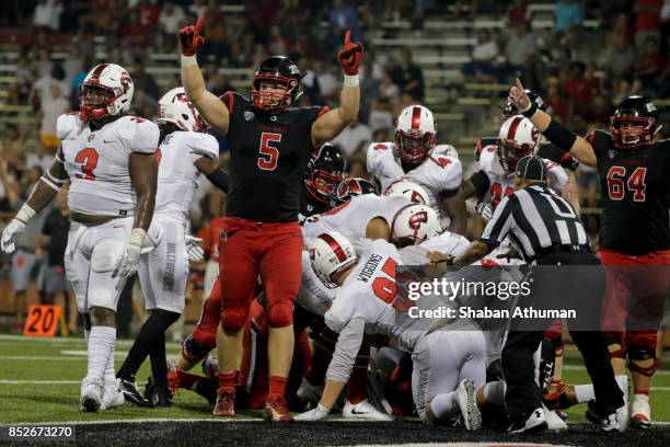 Tight End Danny Pinter of the Ball State Cardinals celebrates after a teammate scored a touchdown against Western Kentucky on September 23, 2017 in...