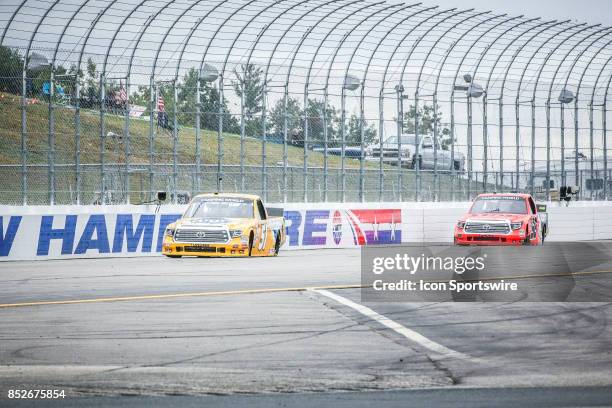 Camping World Truck Series driver Todd Gilliland and Camping World Truck Series driver Grant Enfinger race down the back straight during practice for...