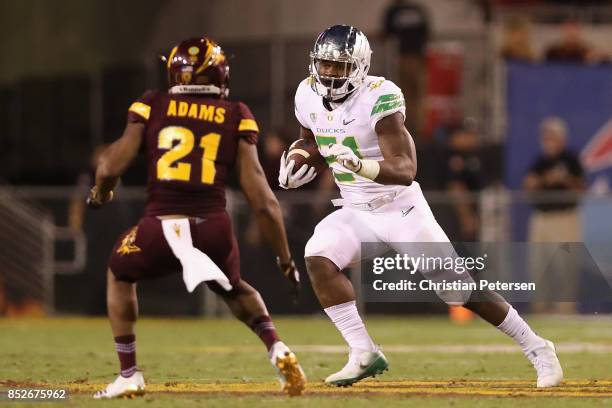 Running back Royce Freeman of the Oregon Ducks rushes the football against defensive back Chad Adams of the Arizona State Sun Devils during the first...