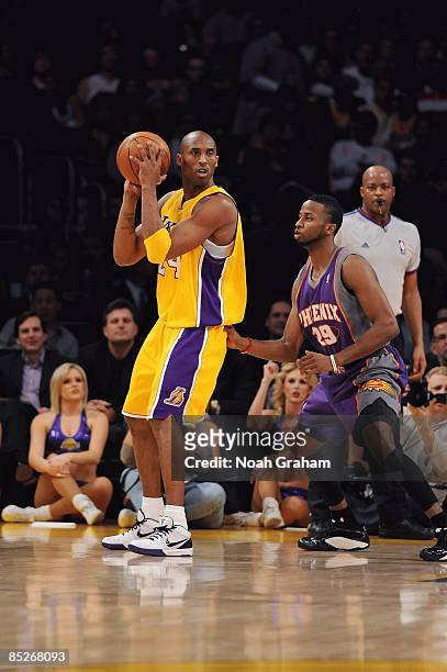 Kobe Bryant of the Los Angeles Lakers drives the ball against Alando Tucker of the Phoenix Suns during the game on February 26, 2009 at Staples...