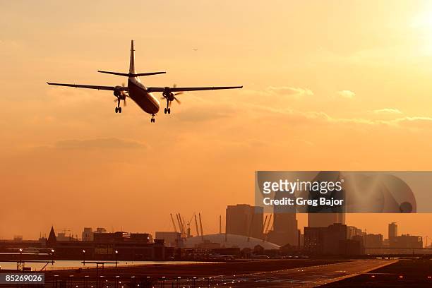 airplane landing on runway - greg bajor stock-fotos und bilder
