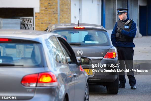 Speaks to a driver near flats in Brixton, south London, as police are conducting house-to-house inquires in the area where three women were allegedly...