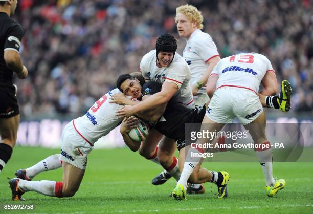 New Zealand's Roger Tuivasa-Scheck is tackled by England's James Roby, Chris Hill and Sean O'Loughlin during the World Cup Semi Final at Wembley...
