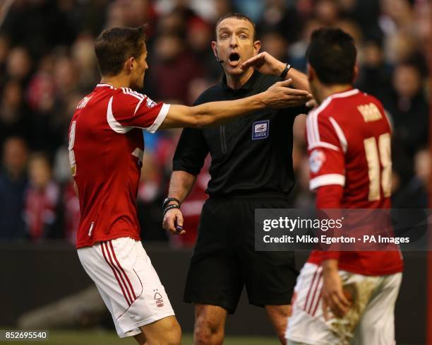 Nottingham Forest's Chris Cohen and Gonzalo Jara argue with referee Carl Boyeson after he awards a Burnley penalty during the Sky Bet Championship...
