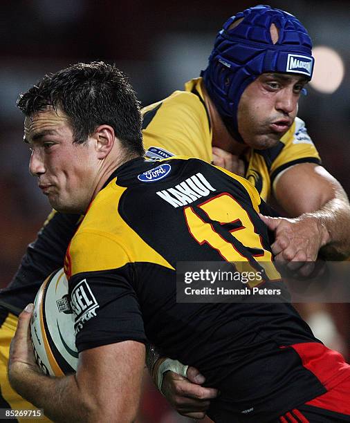 Richard Kahui of the Chiefs fends off Nathan Sharpe of the Force during the round four Super 14 match between the Chiefs and the Western Force at...