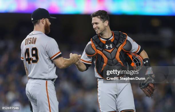 Reliever Sam Dyson and catcher Buster Posey of the San Francisco Giants celebrate after Dyson pitched the ninth inning to pick up the save against...