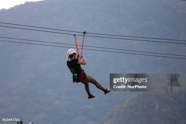 Rio de Janeiro, Brazil, September 23, 2017: Woman crosses the City of Rock using the zipline during the sixth day of the Rock in Rio 2017 festival....