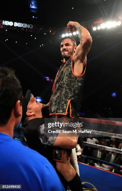 Jorge Linares of Venezuela is held up by coach Jorge Capetillo after defeating Luke Campbell of Great Britain in their WBA lightweight title bout at...