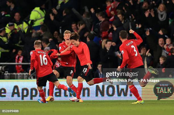 Cardiff City's Bo-Kyung Kim celebrates scoring his teams second goal of the game with teammates