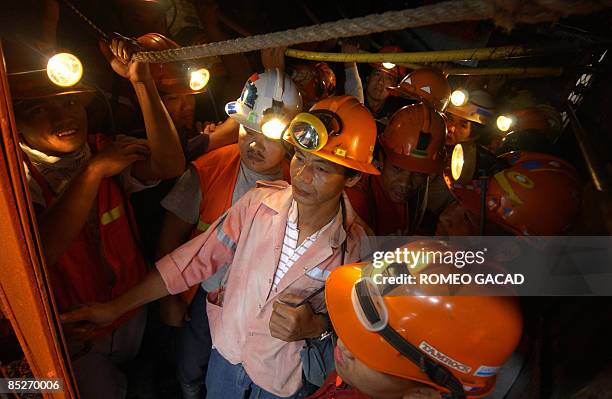 By Cecil Morella In this photo taken May 27, 2006 shows Filipino miners riding an elevator to the mine tunnel of Philex Mining Corp., in Padcal,...