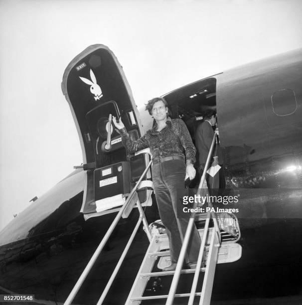 Hugh Hefner, King of the bunnies, steps from his all-black "Big Bunny" aircraft, after his arrival here. He's here to see the rough cuts of his film...