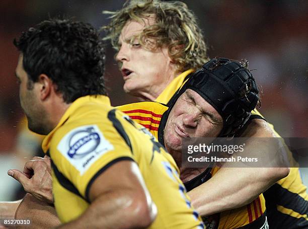 Kevin O'Neill of the Chiefs is caught up by Ryan Cross of the Force during the round four Super 14 match between the Chiefs and the Western Force at...