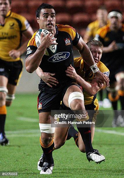 Liam Messam of the Chiefs runs over Josh Valentine of the Force during the round four Super 14 match between the Chiefs and the Western Force at...