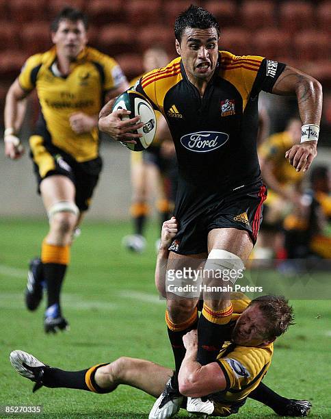 Liam Messam of the Chiefs runs over Josh Valentine of the Force during the round four Super 14 match between the Chiefs and the Western Force at...