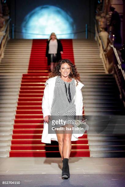 German actress Christine Neubauer walks the runway during the Minx Fashion Night in favour of 'Sauti Kuu' of Auma Obama at Wuerzburger Residenz on...