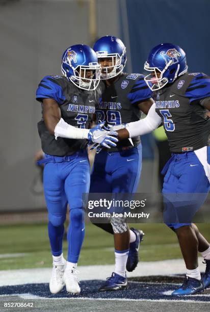 Anthony Miller of the Memphis Tigers celebrates a touchdown with Sean Dykes and Phil Mayhue of the Memphis Tigers against the Southern Illinois...