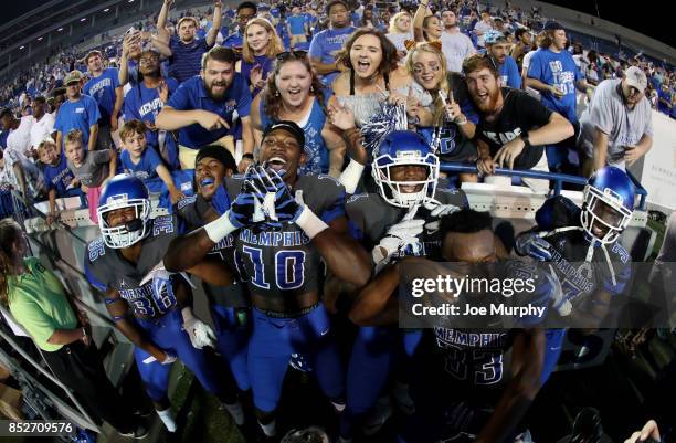 Ladarius Jordan, Jamil Collins and Damonte Coxie of the Memphis Tigers celebrate with fans and teammates after a win against the Southern Illinois...