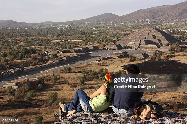 Tourists enjoy the view of the Pyramid of the Moon from the top of the Pyramid of the Sun on February 07, 2009 in Teotihuacan, Mexico. The ancient...