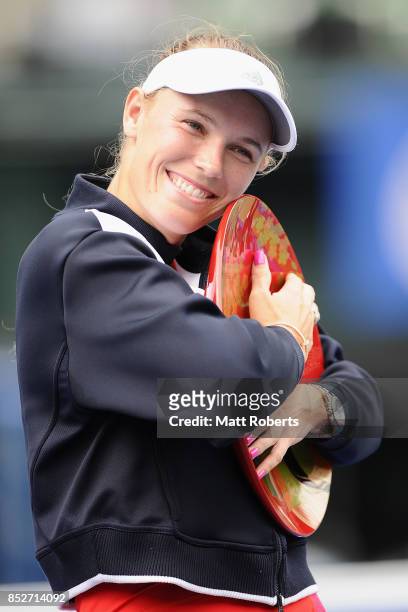 Caroline Wozniacki of Denmark pose with the winners trophy after defeating Anastasia Pavlyuchenkova of Russia in the women's singles final match on...