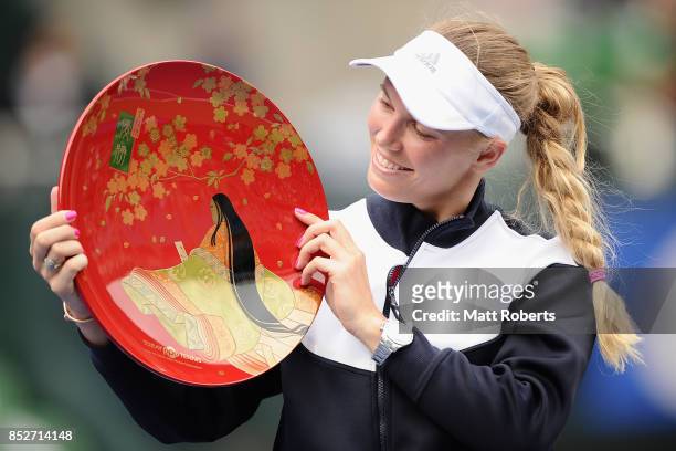 Caroline Wozniacki of Denmark pose with the winners trophy after defeating Anastasia Pavlyuchenkova of Russia in the women's singles final match on...