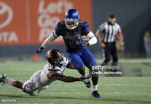 Darrell Henderson of the Memphis Tigers breaks a tackle against Jeremy Chinn of the Southern Illinois Salukis on September 23, 2017 at Liberty Bowl...