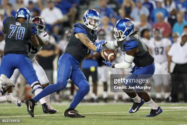 Riley Ferguson of the Memphis Tigers hands the ball off to Darrell Henderson of the Memphis Tigers against the Southern Illinois Salukis on September...