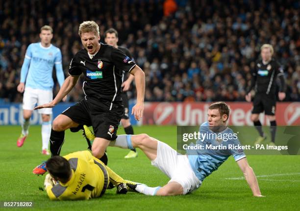 Plzen's Vaclav Prochazka and goalkeeper Matus Kozacik battle for the ball with Manchester City's James Milner