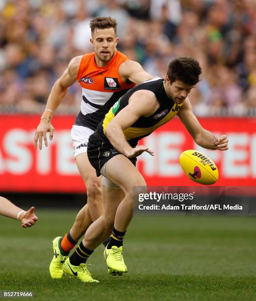 Trent Cotchin of the Tigers is tackled by former Tigers teammate Brett Deledio of the Giants playing his 250th game during the 2017 AFL Second...