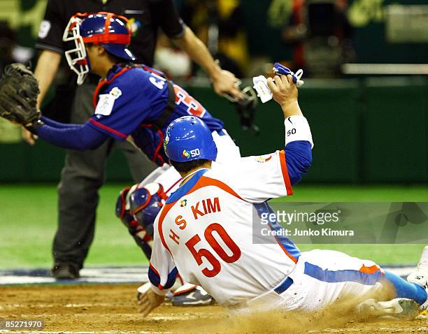 Outfielder Kim Hyun-Soo of South Korea scores in the bottom of the sixth inning during the World Baseball Classic Tokyo Round match between Chinese...