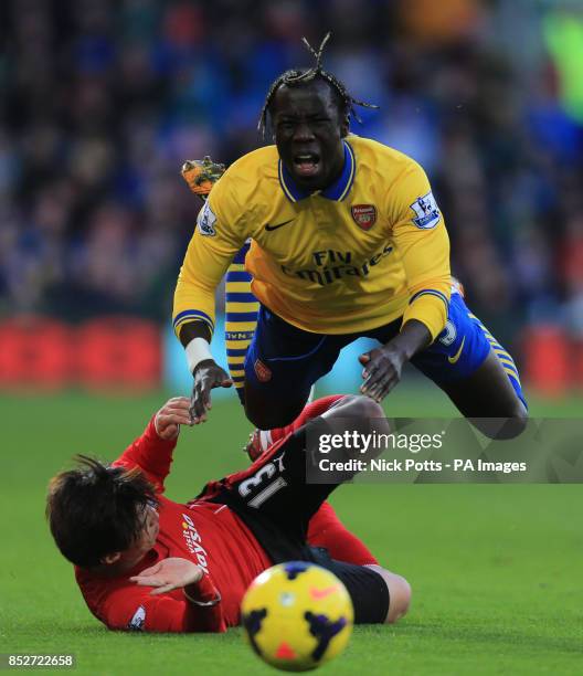 Arsenal's Bacary Sagna is tackled by Cardiif City's Kim Bo-Kyung during the Barclays Premier League match at Cardiff City Stadium, Cardiff.