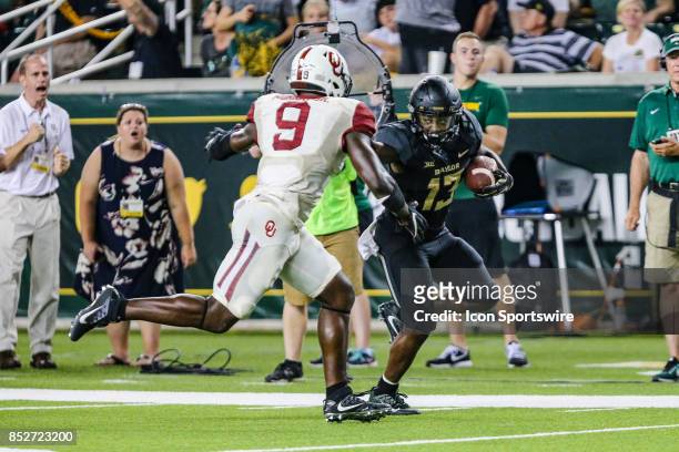 Baylor Bears wide receiver Tony Nicholson stiff arms Oklahoma Sooners linebacker Kenneth Murray during the game between the Baylor Bears and the...