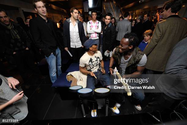 Florent Malouda and Michael Essien play rockstar during the Chelsea FC and Armani charity party at The Armani Store, Brompton Road where the proceeds...