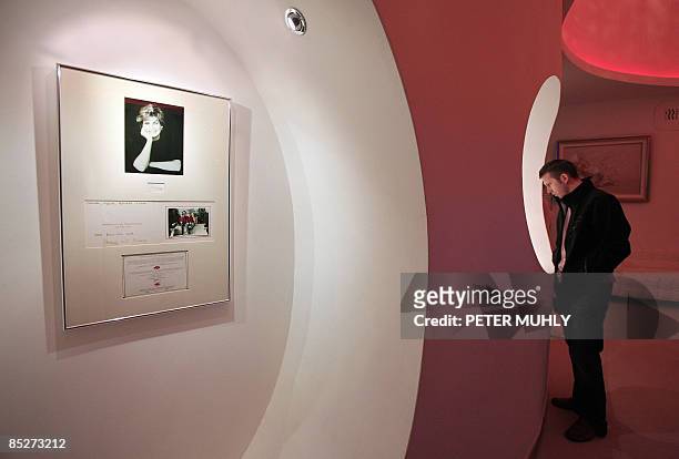 Signed print of the late Princess Diana and a Christmas card from Diana and Britain's Prince Charles are pictured on the opening day of an exhibition...