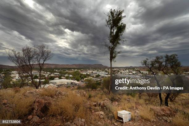 Discarded lager box is seen in the foreground as heavy rain clouds are seen above Alhekulyele part of the MacDonnell Ranges in Alice Springs,...