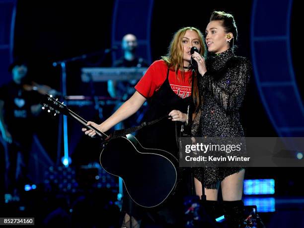 Brandi Cyrus and Miley Cyrus perform onstage during the 2017 iHeartRadio Music Festival at T-Mobile Arena on September 23, 2017 in Las Vegas, Nevada.