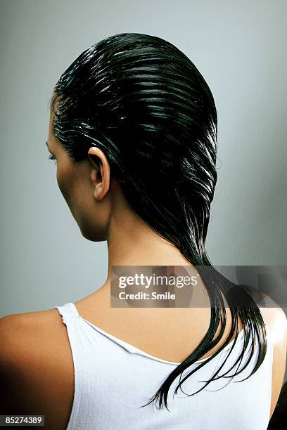 young woman with wet hair combed over shoulder - wet hair fotografías e imágenes de stock