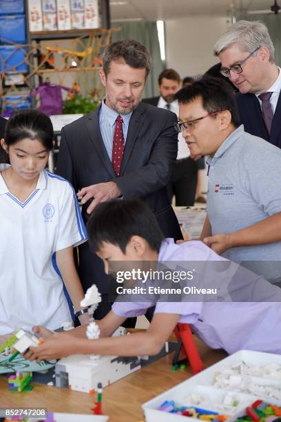 Crown Prince Frederik of Denmark and Danish Minister of Higher Education, Soren Pind discuss with a certified LEGO educator during their visit at the...