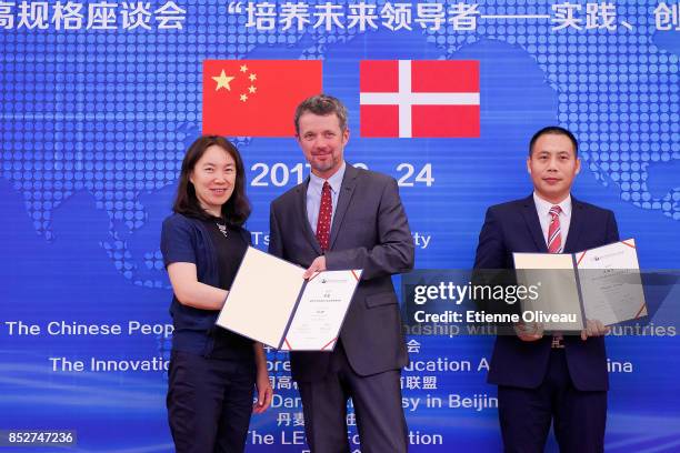 Crown Prince Frederik of Denmark hands over a certificate to a student during the Opening of the Sino-Danish high-level seminar, Educating the...