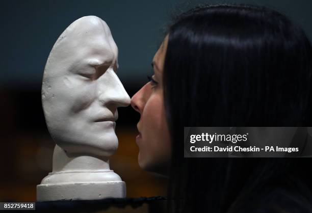 Sir Isaac Newton's death mask held by staff member Emma Smith is part of an exhibition of 150 fascinating items from Edinburgh University's...