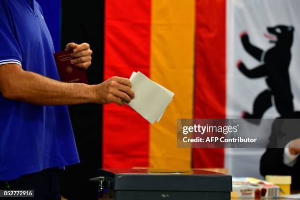 Man casts his ballot at a polling station in Berlin during general elections on September 24, 2017. Polls opened in Germany in a general election...