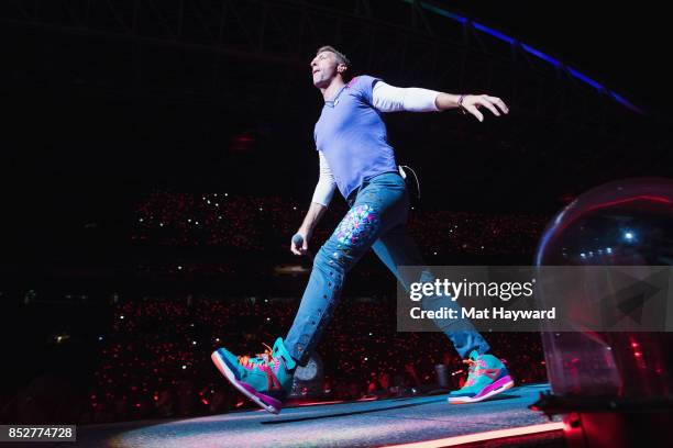 Chris Martin of Coldplay performs on stage at CenturyLink Field on September 23, 2017 in Seattle, Washington.