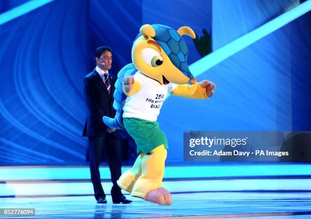 Former Brazilian soccer player Bebeto presents World Cup mascot Fuleco during the FIFA 2014 World Cup Draw at the Costa Do Sauipe, Salvador, Bahia.