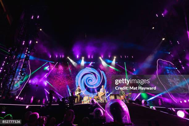 Jonny Buckland, Will Champion, Chris Martin and Guy Berryman of Coldplay perform on stage at CenturyLink Field on September 23, 2017 in Seattle,...