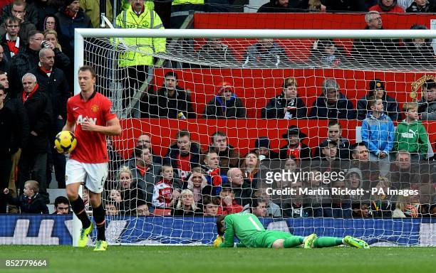 Manchester United goalkeeper David de Gea lies dejected after conceding the first goal of the game