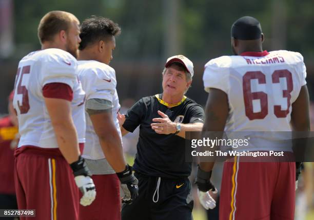 Washington offensive line coach Bill Callahan, center, talks with guard Brandon Scherff , left, guard Shawn Lauvao and guard Isaiah Williams , right,...