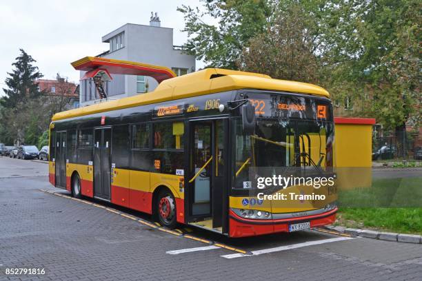 electric bus on the charging station - warsaw bus stock pictures, royalty-free photos & images