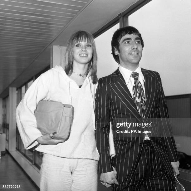 The Who drummer Keith Moon and his girlfriend Annette Walter-Lax land at Heathrow Airport from Los Angeles, where they have been living.