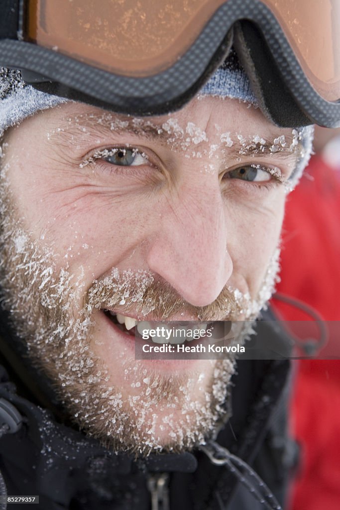 A man with a frosty beard smiles.