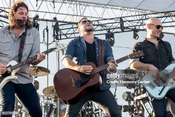James Young, Mike Eli and Jon Jones of the Eli Young Band perform at Coastal Country Jam at Huntington State Beach on September 23, 2017 in...