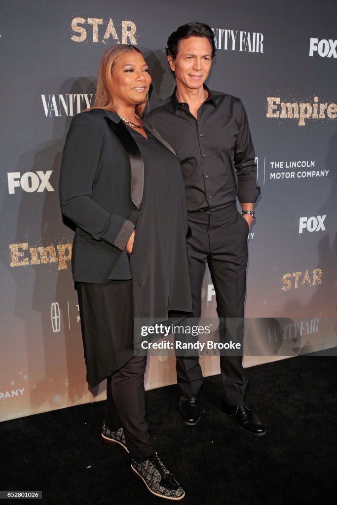 Benjamin Bratt and Queen Latifah pose on the red carpet with her
